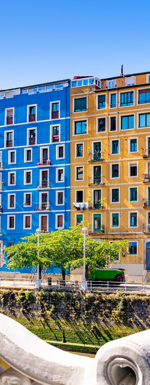 Colorful riverside buildings in sunny cityscape