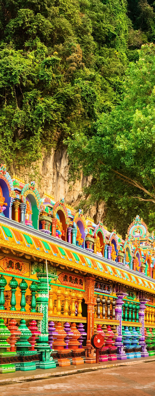 Colorful Hindu temple and golden statue outdoors