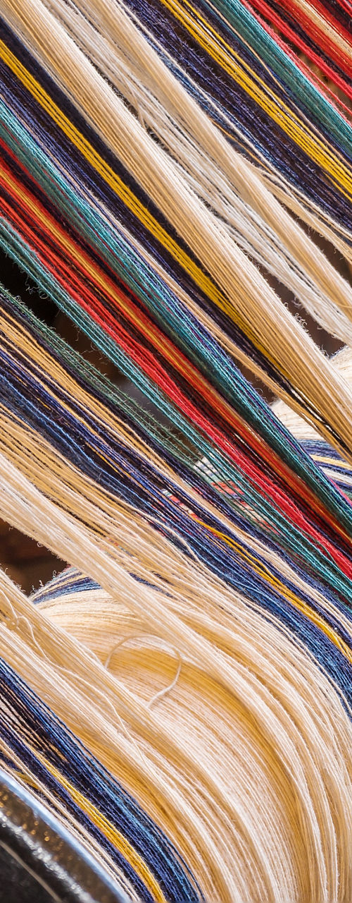Colorful textile threads on weaving loom