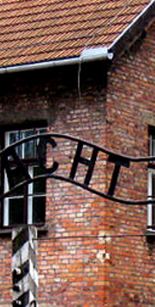 Historic Auschwitz entrance with iron sign