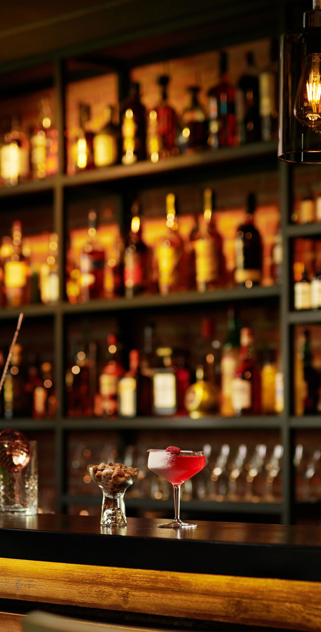 Cozy bar with cocktails and warm lighting