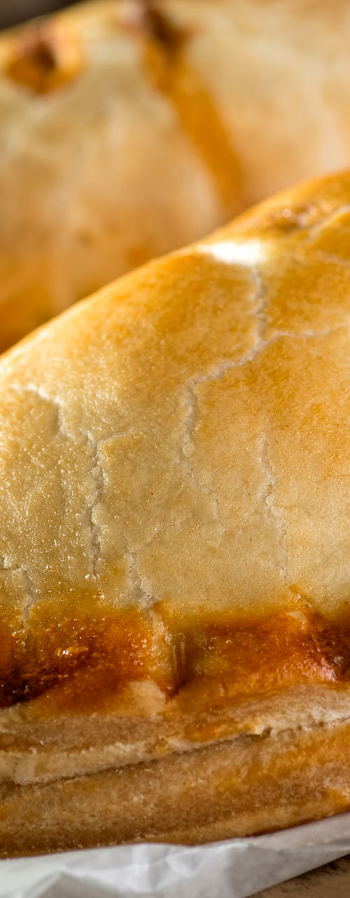 Golden baked pasties on parchment paper