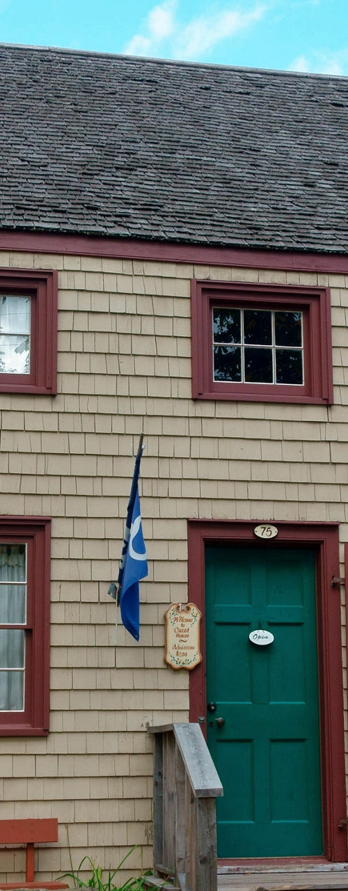 Historic colonial-style house with flag