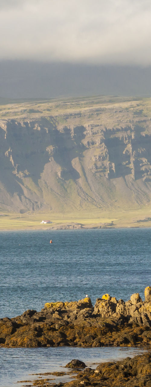 Coastal cabin with boat and rocky shore