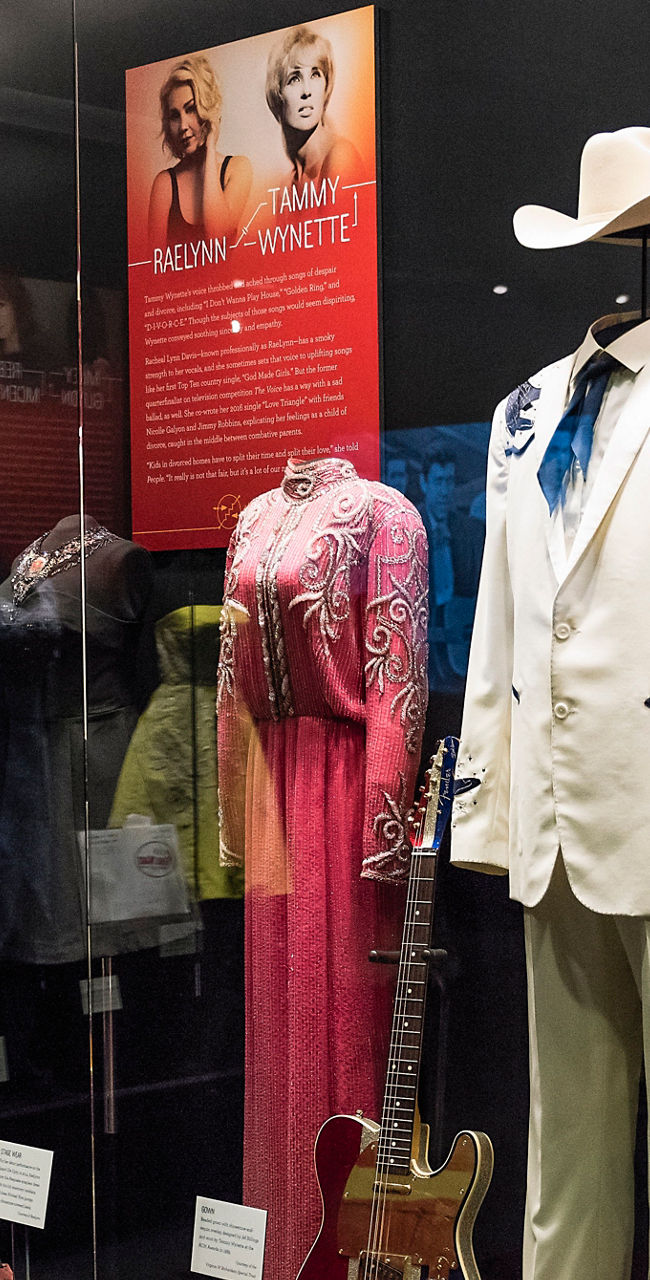 Country music exhibit with iconic outfits