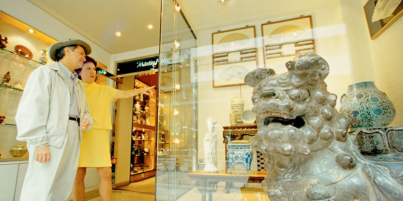 Tourists admire antique shop display