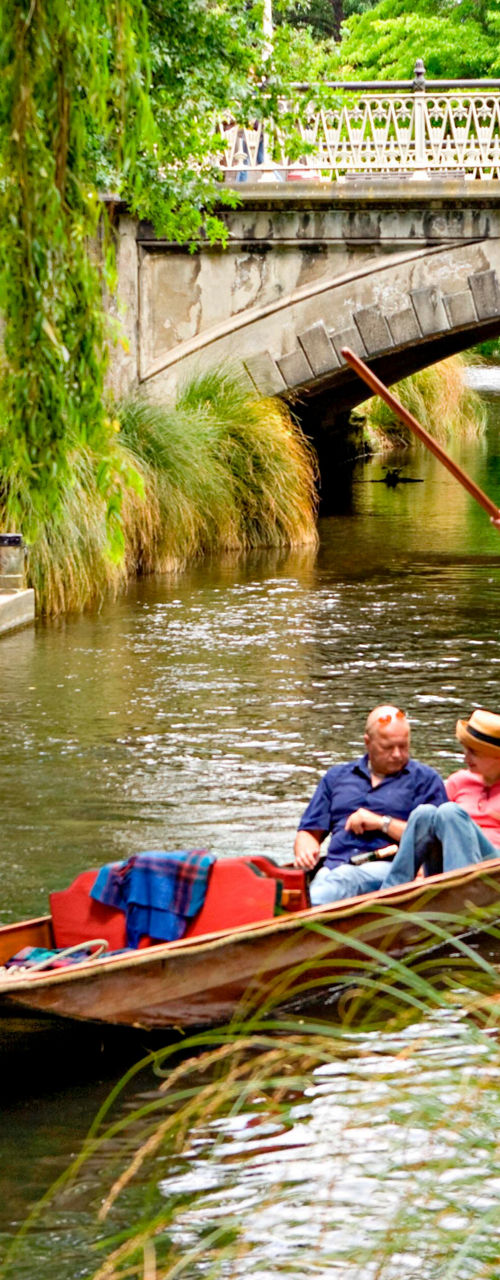 Scenic river punting under historic bridge
