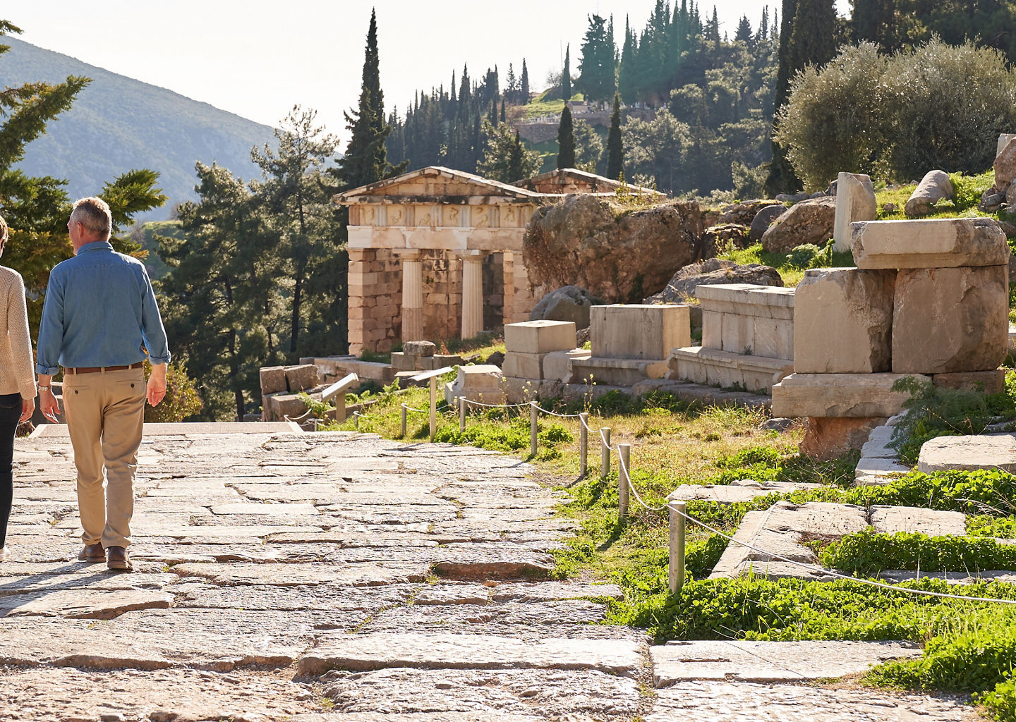 Couple exploring ancient ruins in sunlight