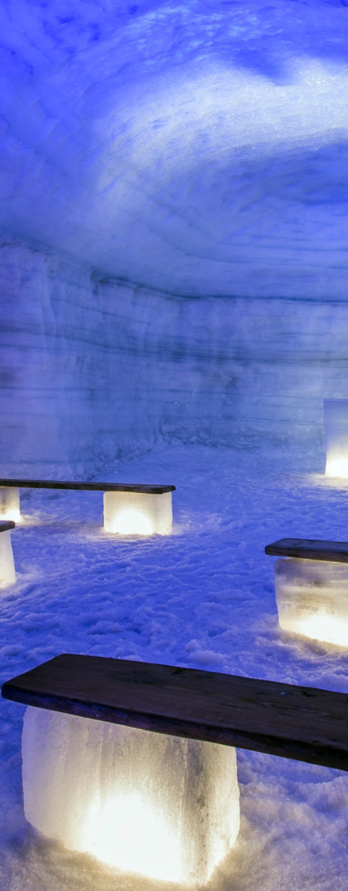 Illuminated Ice Cave with Benches