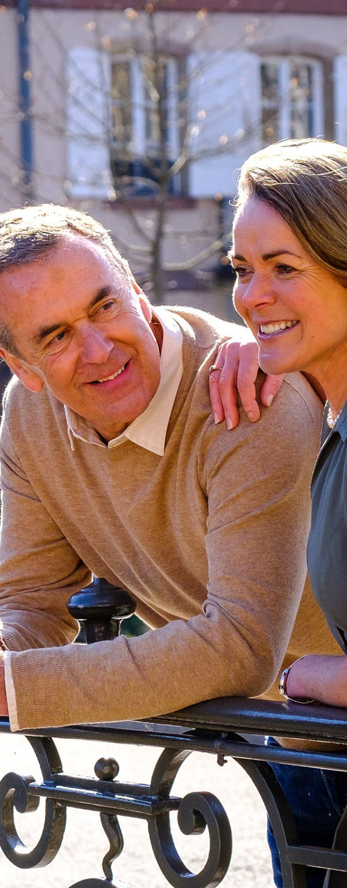 Couple leaning on ornate railing outdoors