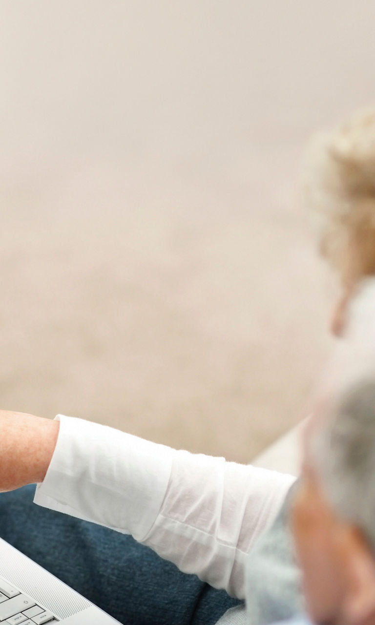 Older couple browsing travel options online