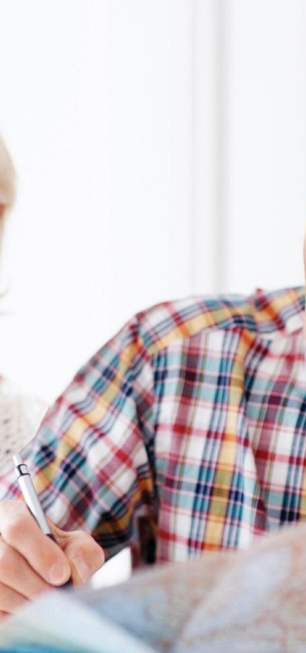 Senior couple planning trip with map
