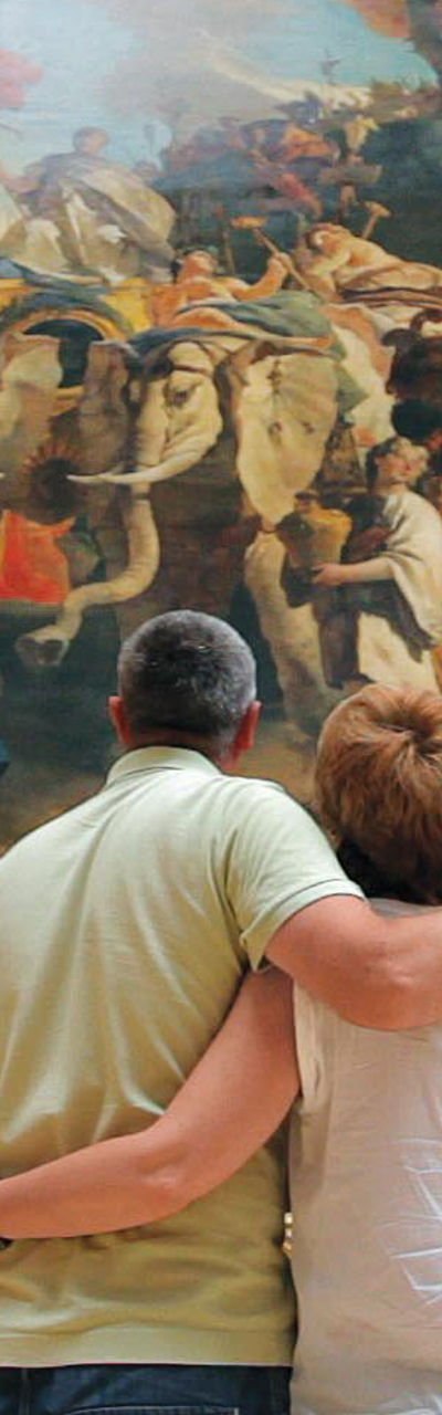 Couple admiring large framed painting