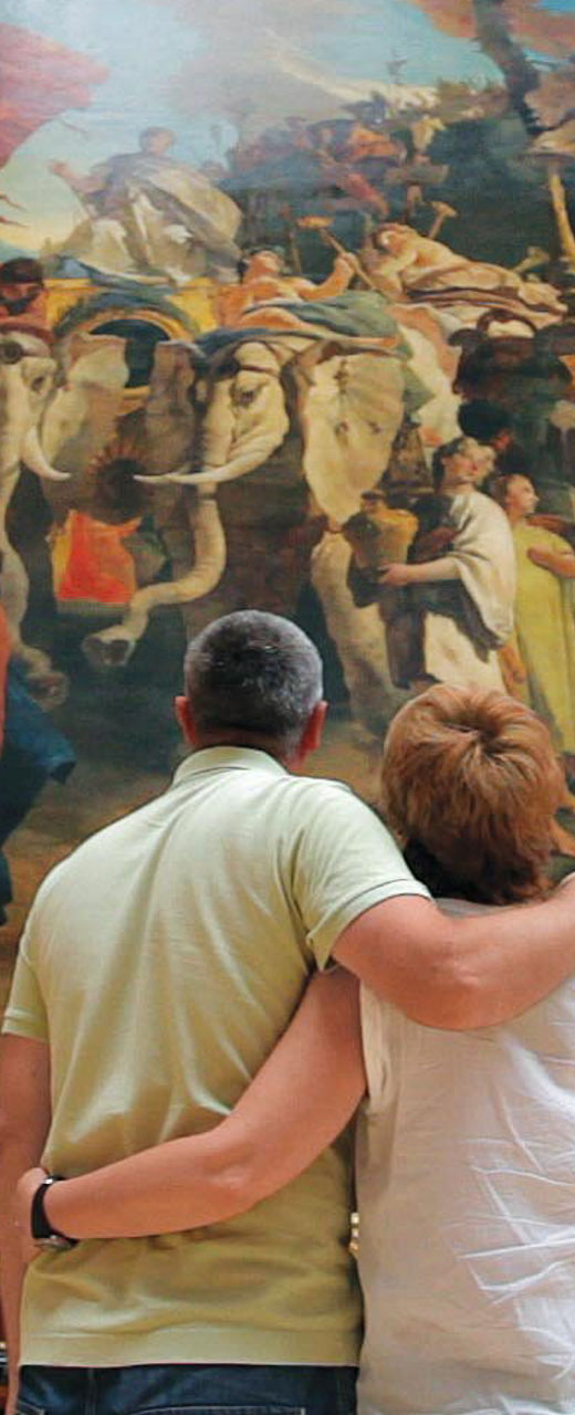 Couple admiring large framed painting