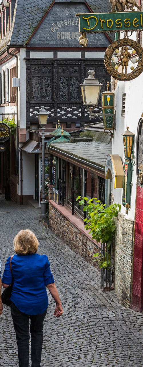 Couple walking in charming cobblestone alley