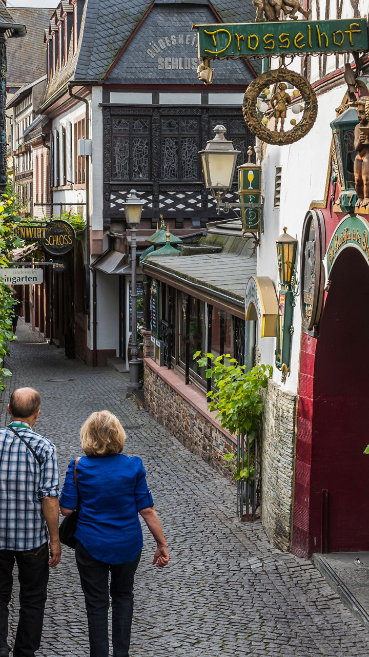 Couple walking in charming cobblestone alley