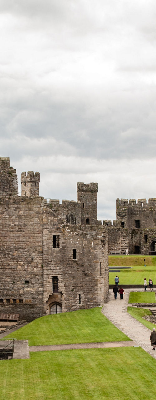 Historic stone castle with green courtyard