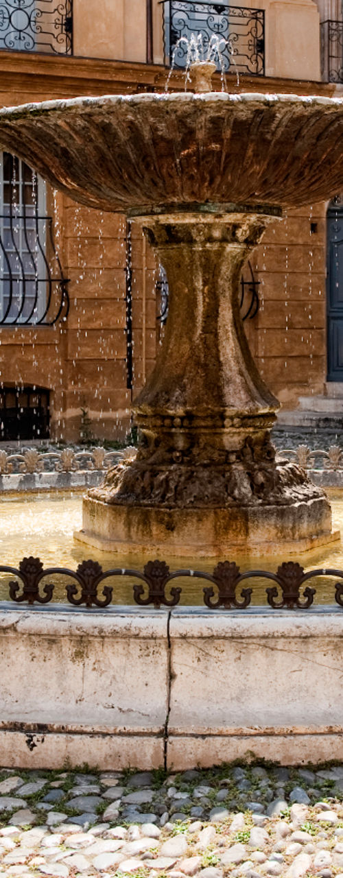 Historic stone fountain in European courtyard