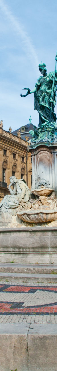 Historic palace with central fountain statue