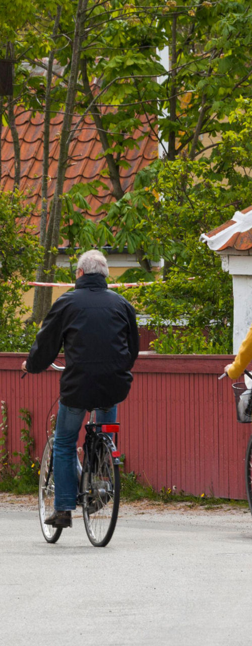 Two cyclists in a quaint village setting