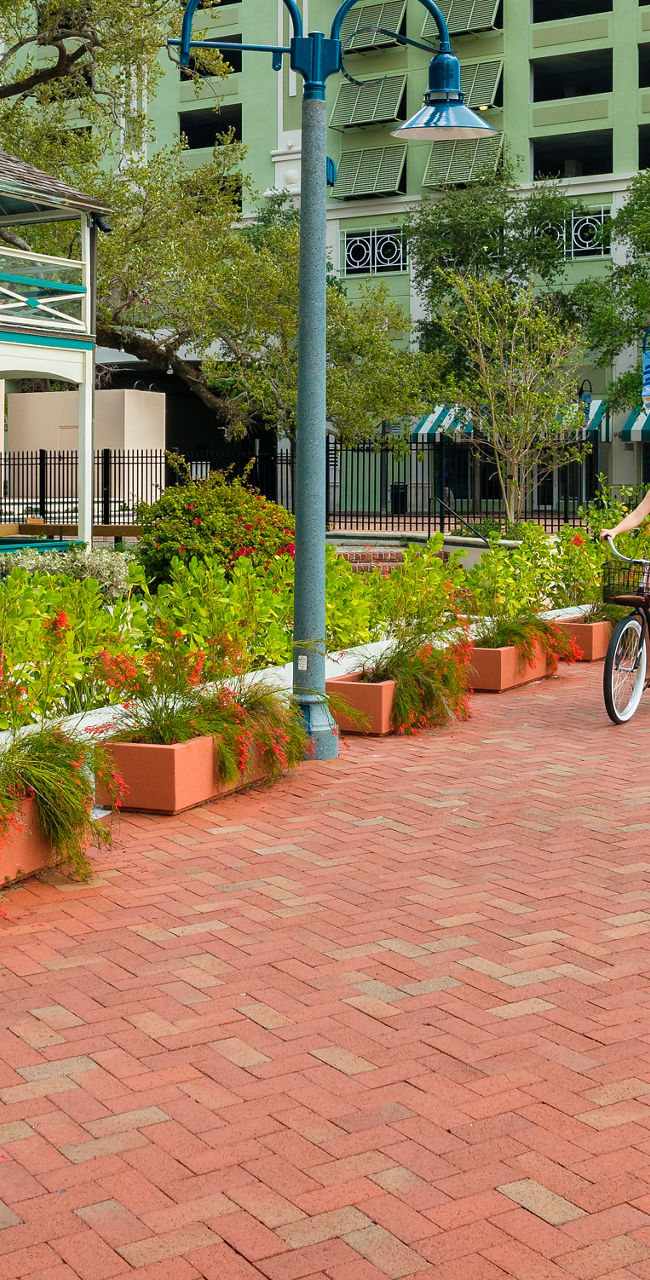 Cyclists on waterfront brick pathway