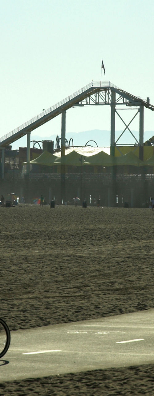 Cyclists near beach and amusement park