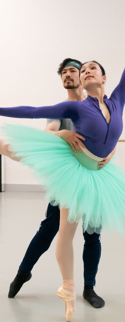 Ballet dancers practicing elegant partnered pose