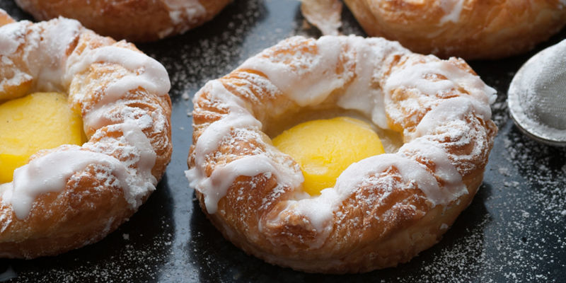 Freshly baked pastries with icing sugar