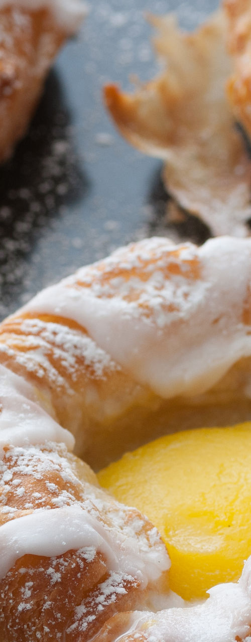 Freshly baked pastries with icing sugar