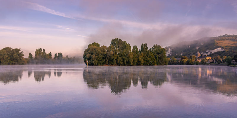 Serene river landscape with morning mist