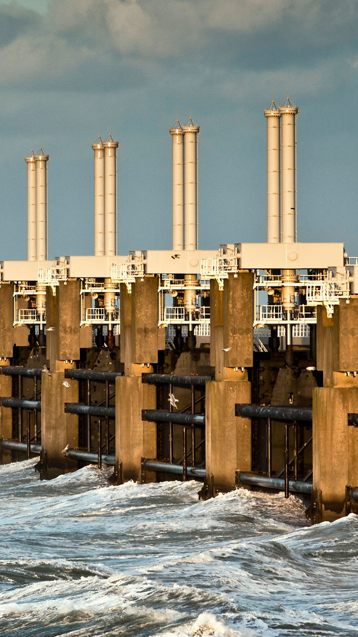 Coastal storm surge barrier with crashing waves