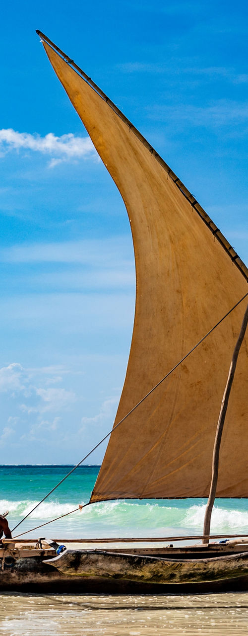 Traditional wooden sailboats on tropical beach