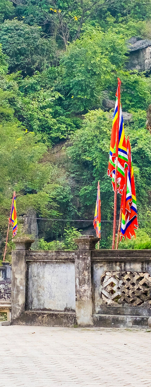 Ancient stone gate with colorful flags