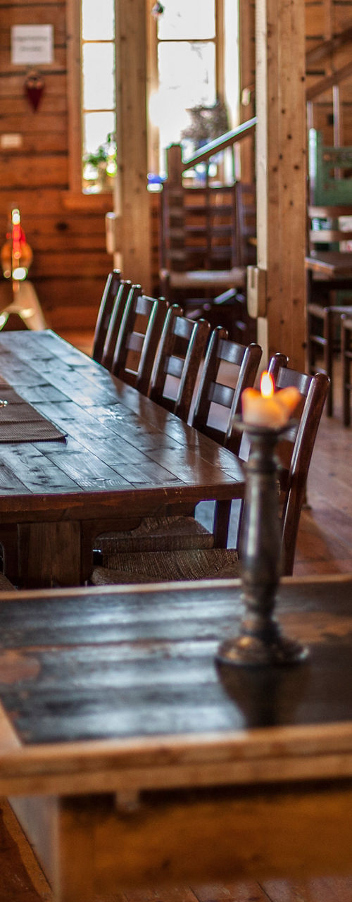 Rustic wooden dining hall with long tables