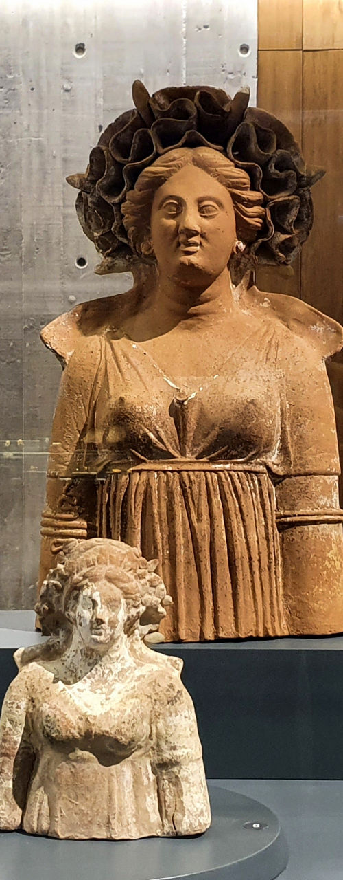 Ancient terracotta statues and vases in museum