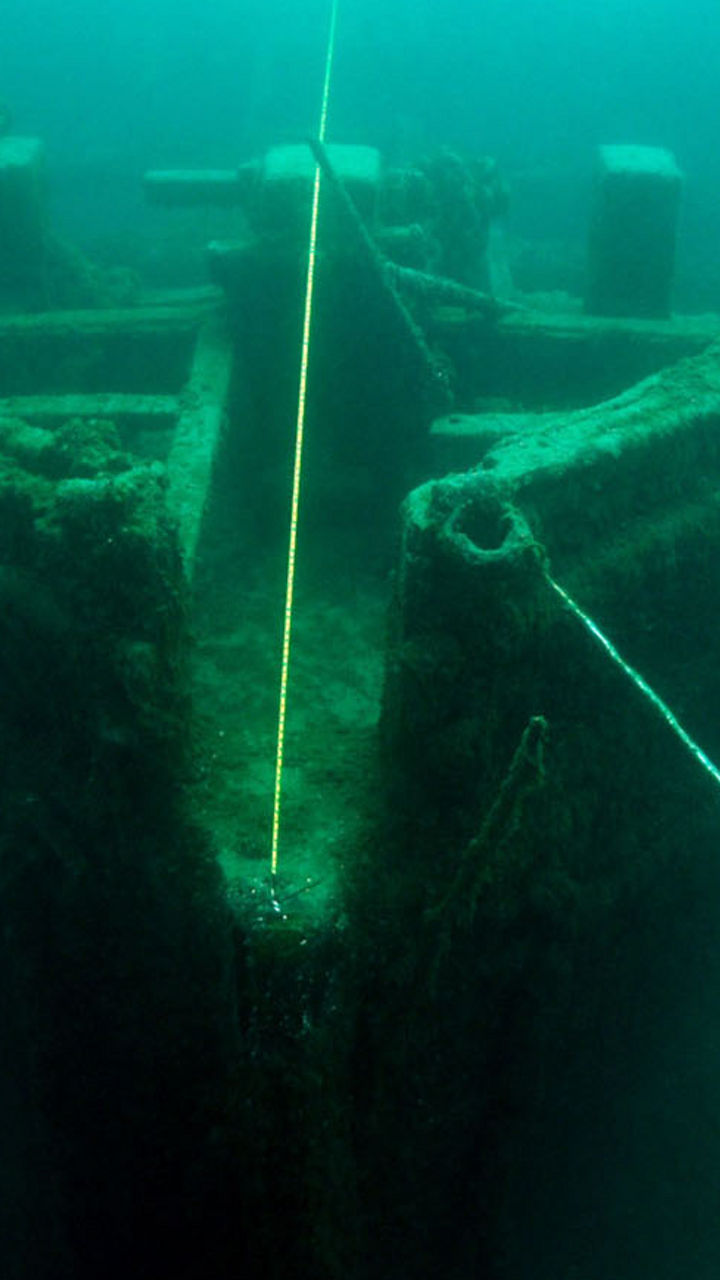 Underwater diver exploring shipwreck remains