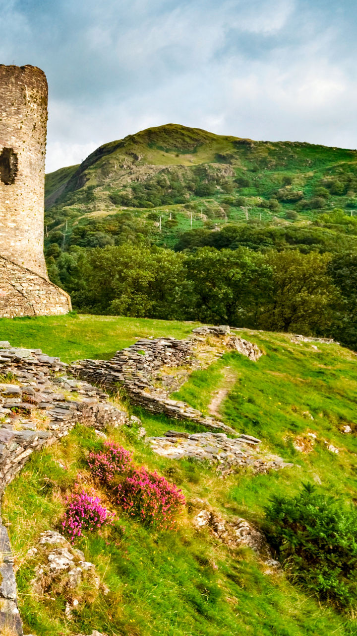 Historic stone castle in lush green valley