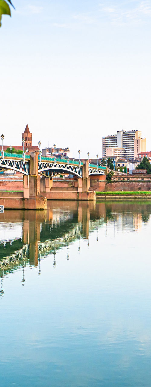 Scenic bridge over calm river at sunrise