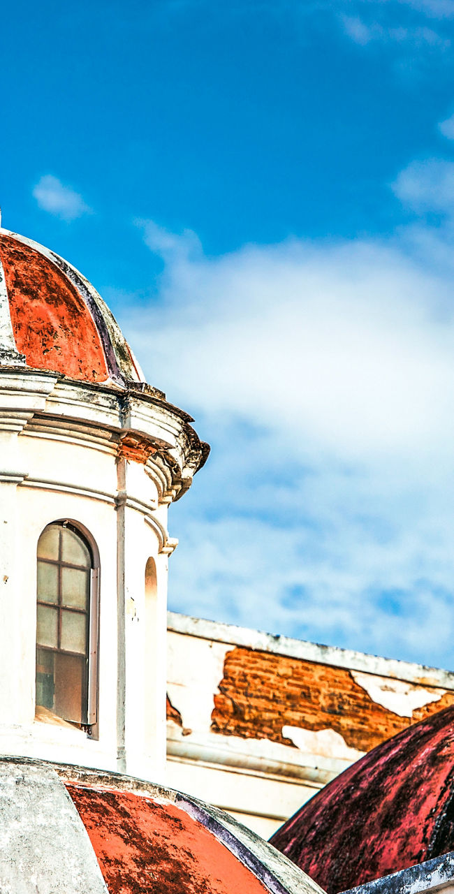 Historic red-domed church under blue sky