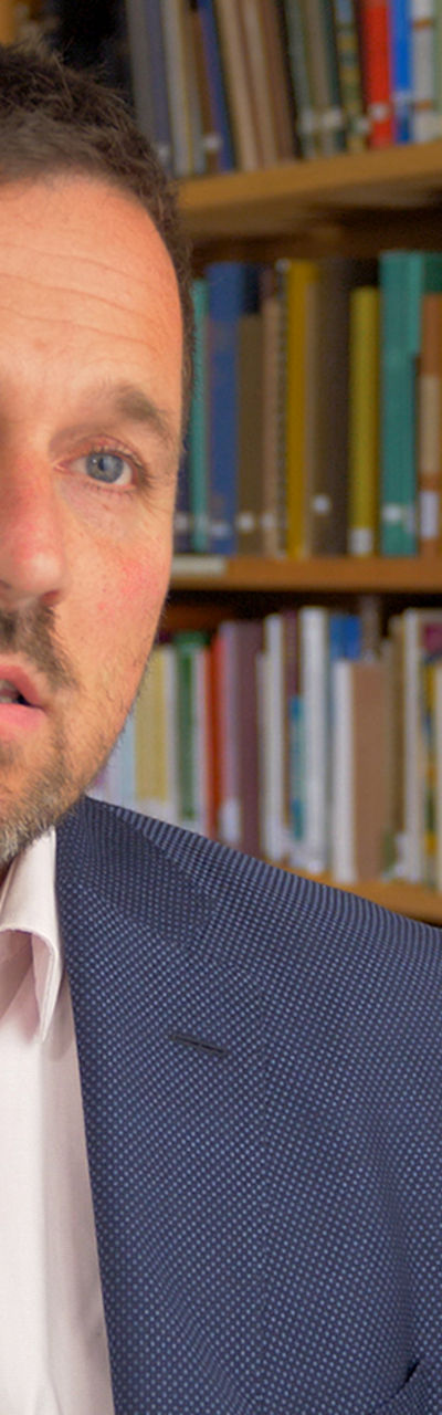 Man in formal attire in library setting