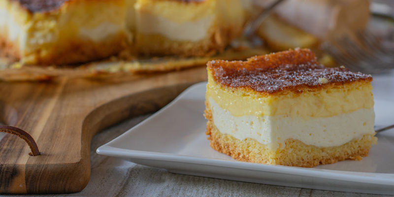 Slice of creamy layered cheesecake on plate