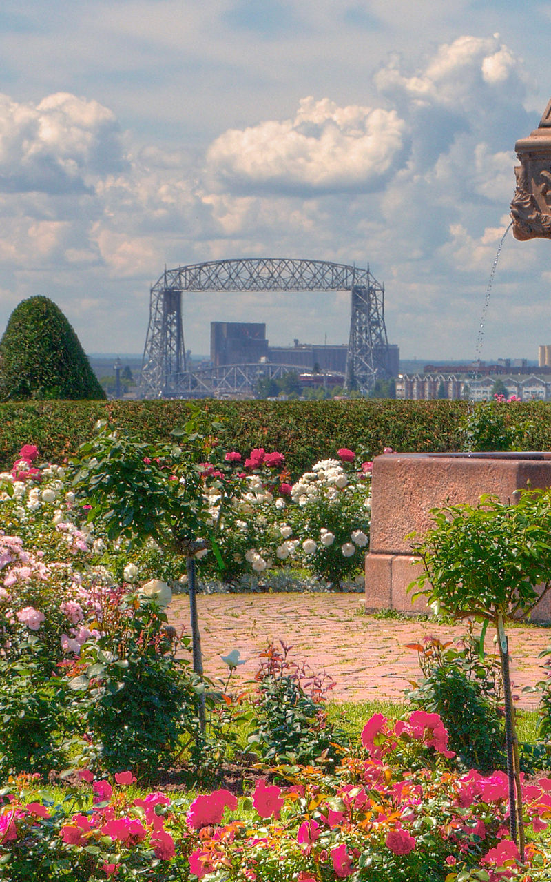 Rose garden with historic fountain and city view