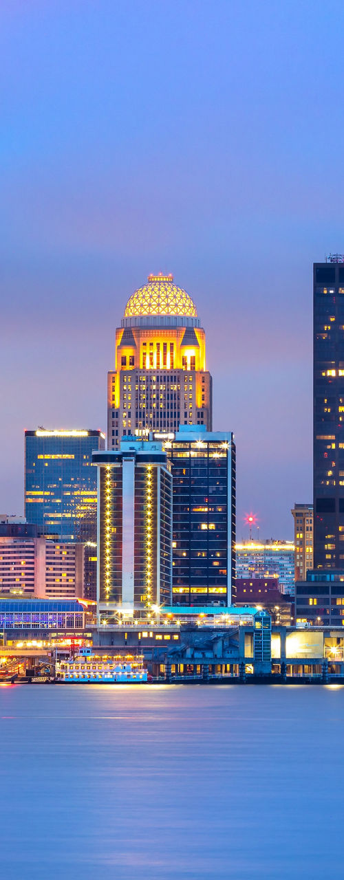 Downtown city skyline at dusk with river view