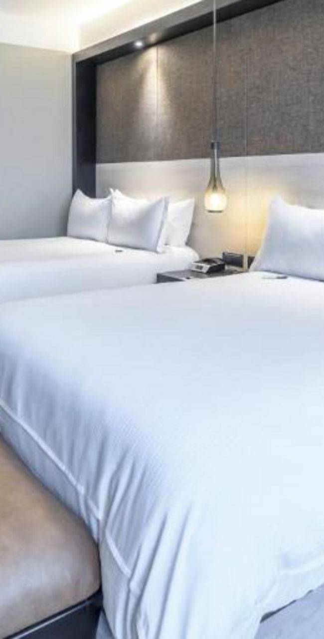 Modern hotel room with two double beds