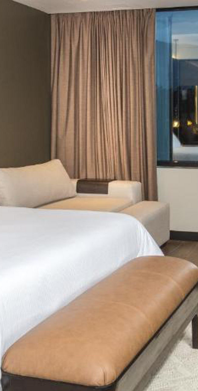 Modern hotel room with king bed and desk