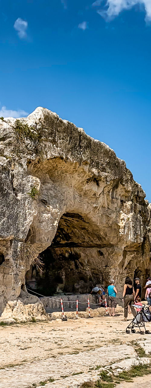 Ancient rock caves under clear blue sky