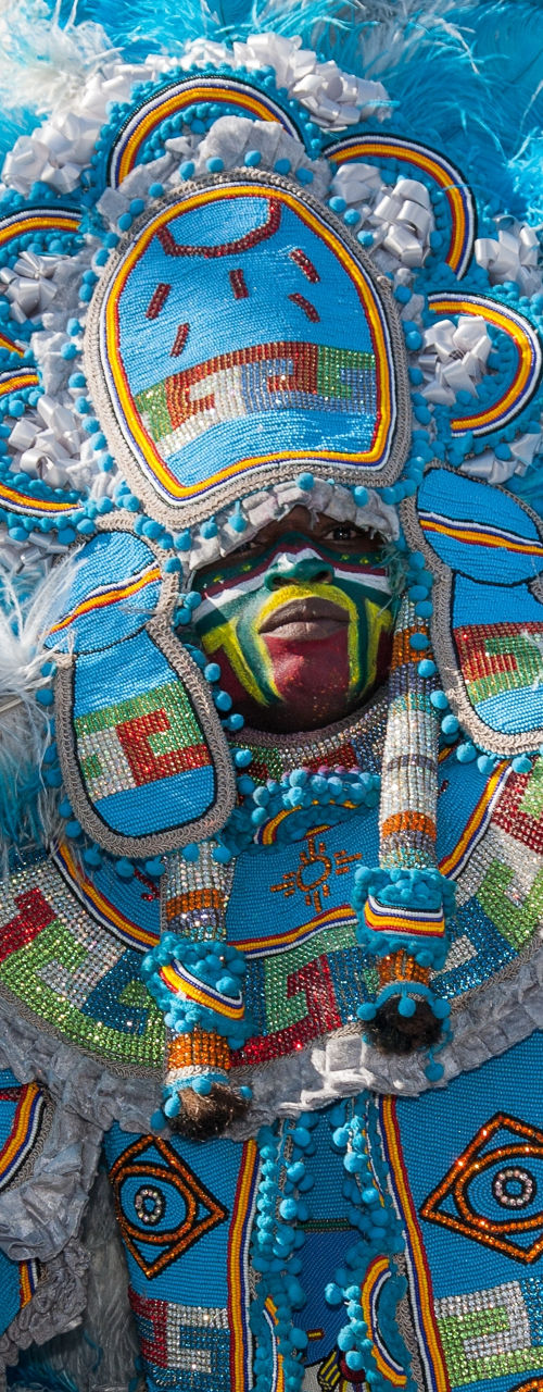 Vibrant Mardi Gras Indian in blue feathers