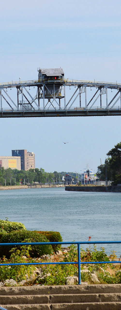 Canal bridge with flags and waterfront view