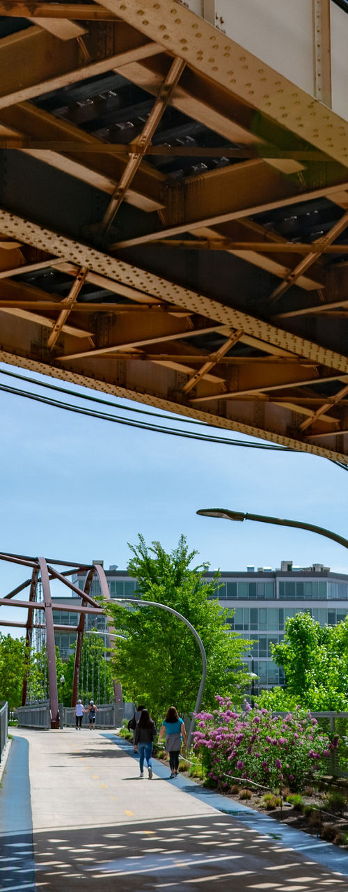 Urban pedestrian walkway under elevated train tracks