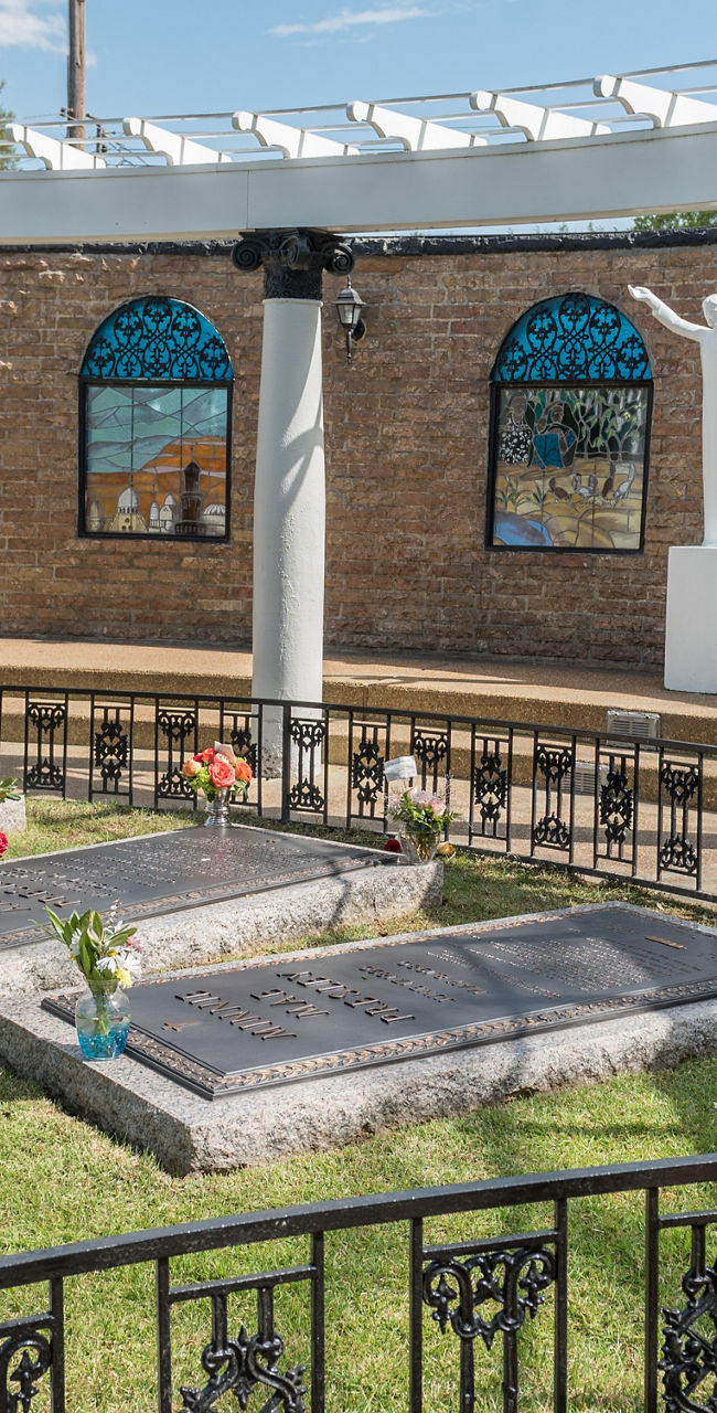 Outdoor memorial site with pool and flowers